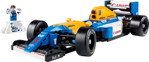 Toy Formula 1 car with detailed design and a small figure beside it.
