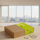Puzzlers packaging with a brown box and green label on a black surface with puzzle pieces.